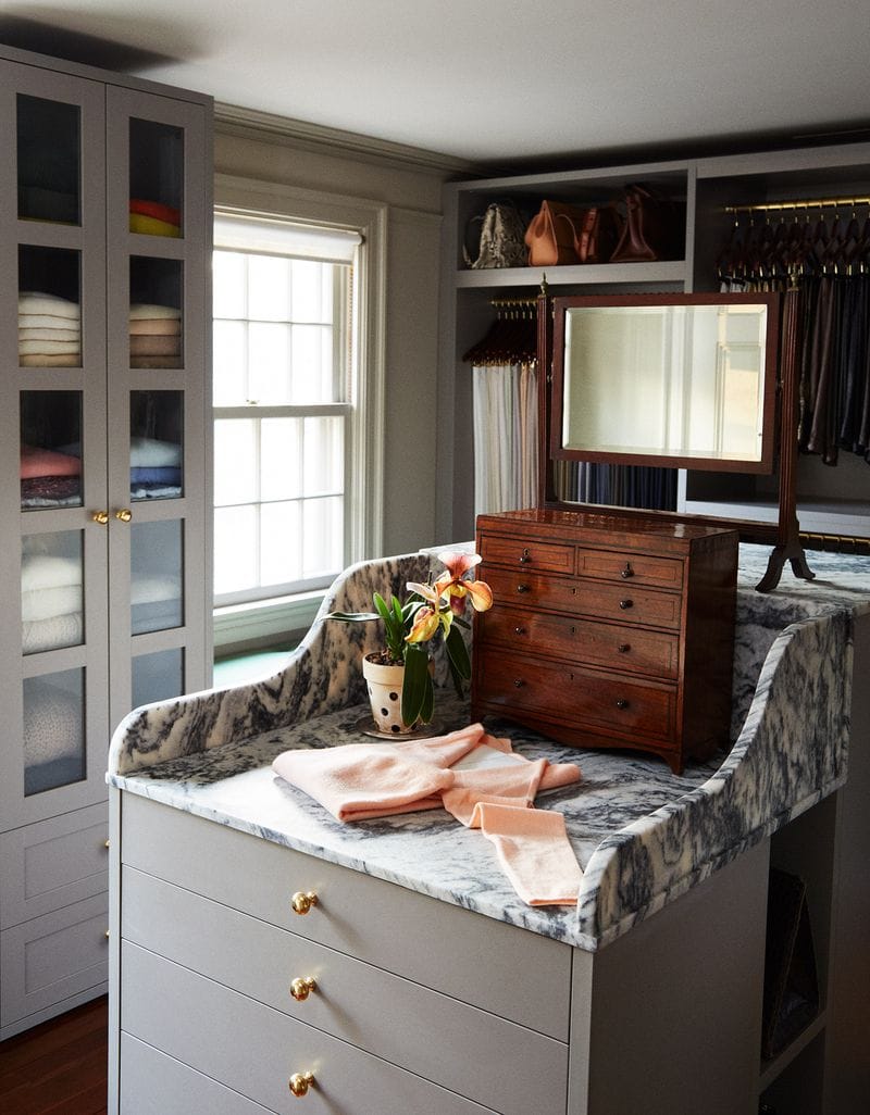 Martha Stewart's curated custom closet with glass cabinet drawers, purse storage and center island created by California Closets