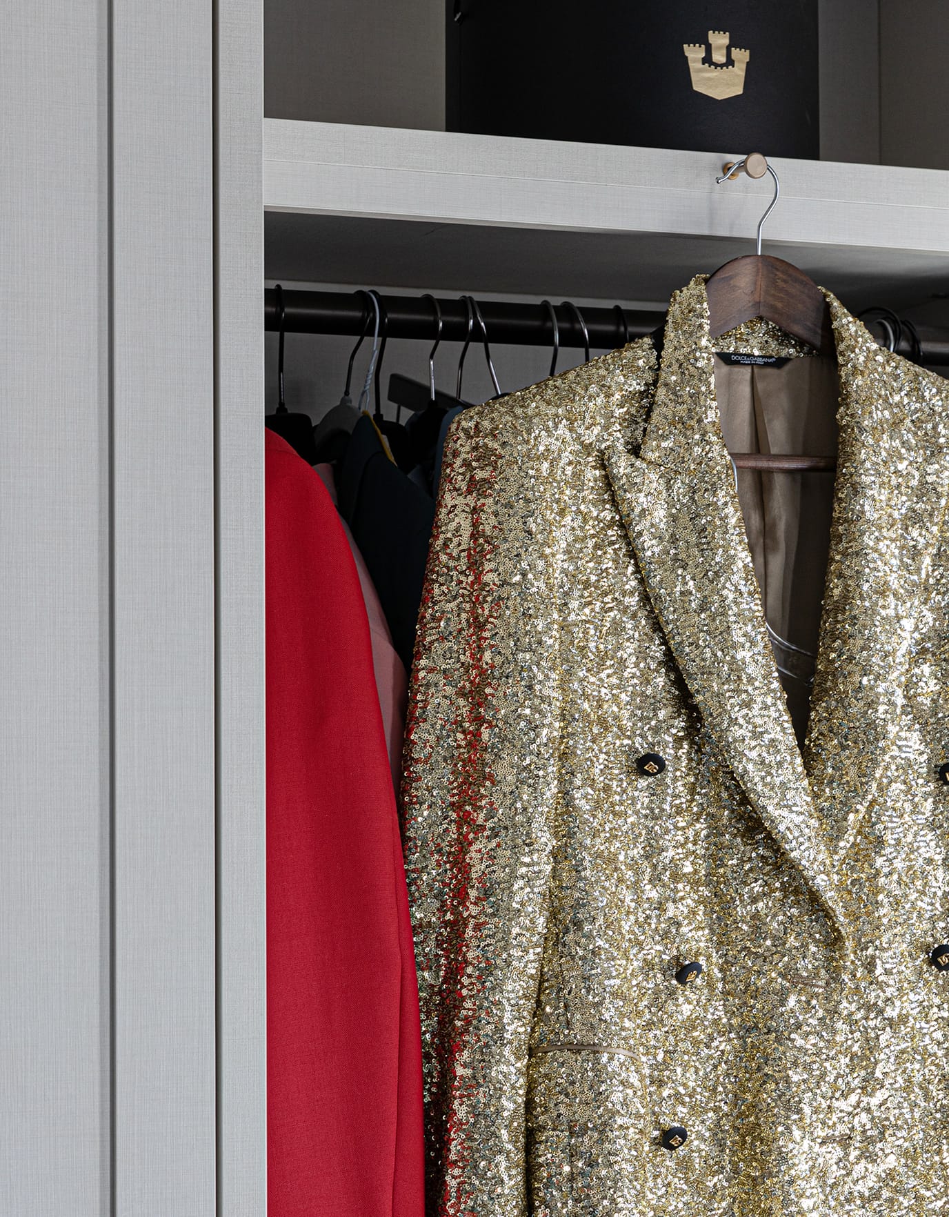 A California Closets wardrobe closet door opened to show Jon Batiste's custom gold blazer