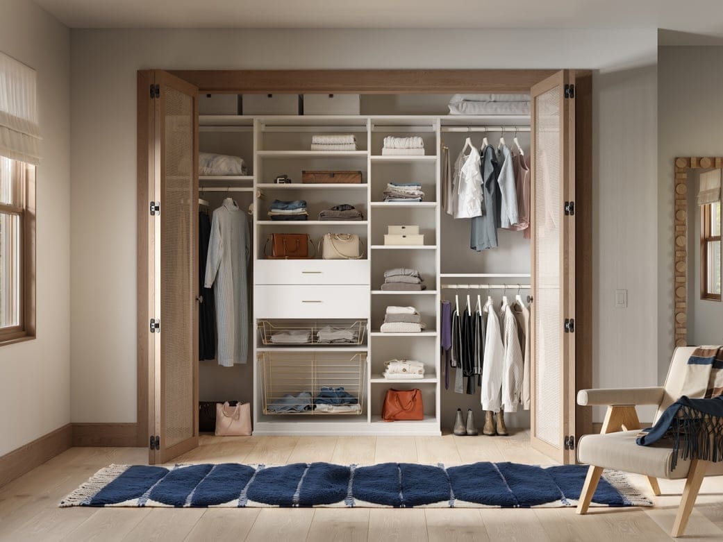 Designed with custom drawers and reach in closet, cubbies, and open shelving by California Closets